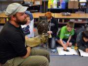 Ridgefield: Audubon Society of Portland environmental educator Tim Donner shows an owl named Julio to fifth-grade art students at Union Ridge Elementary on Oct. 25.