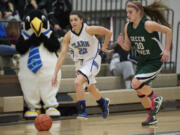 Clark College basketball player Dominique Johnson drives the ball up court during a game against Green River, February 9, 2013.(Steven Lane/The Columbian)