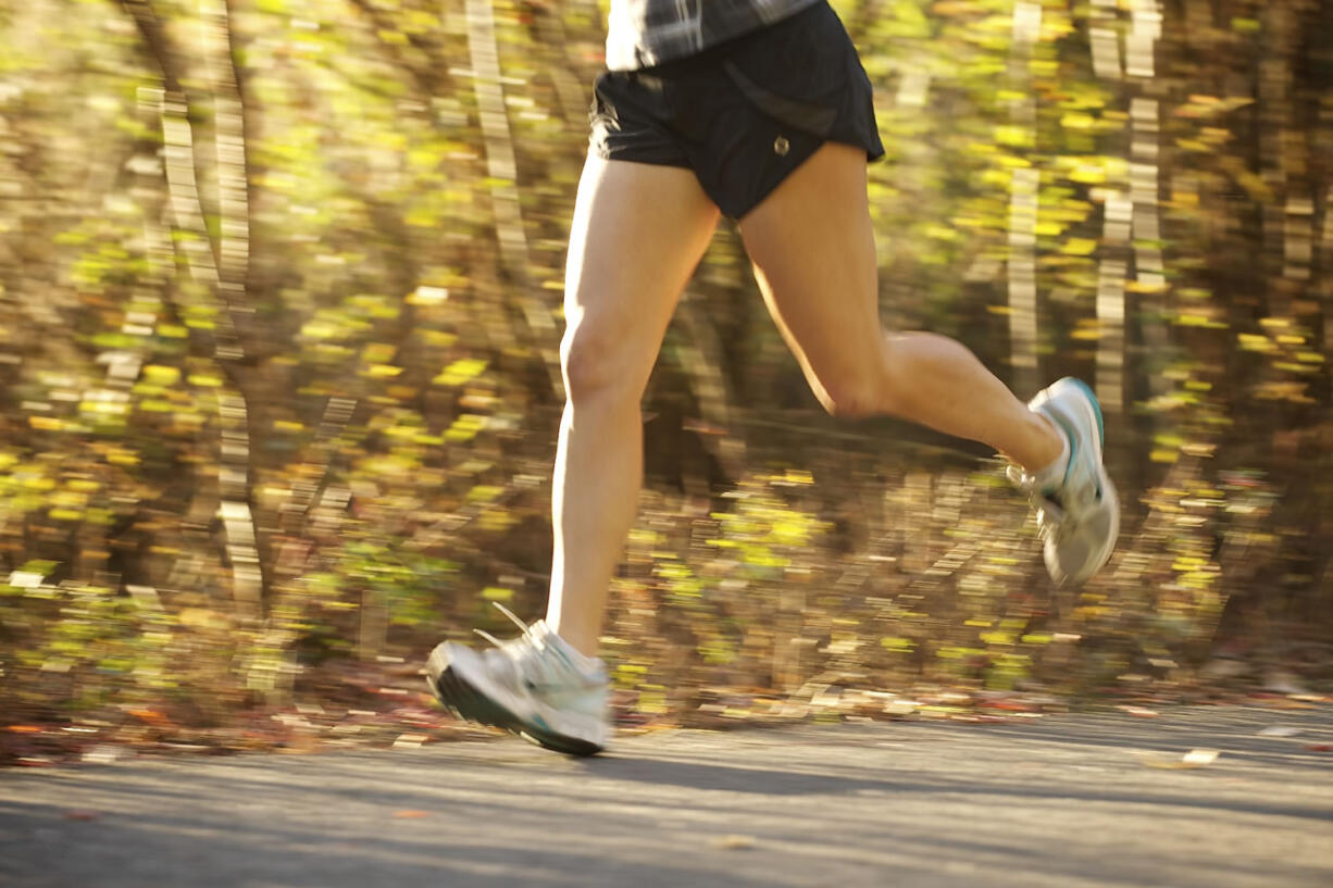 A runner runs along the Salmon Creek Trail in Vancouver on Wednesday.