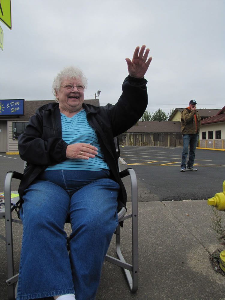 Stefanie Donahue/The Columbian 
 Jo Wright waves to Harvest Days parade participants on Saturday. Wright enjoys parades and has attended more than 50 as she travelled across the country, she said.