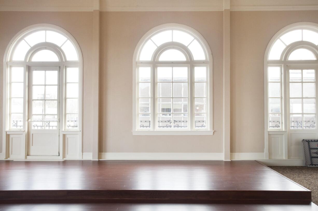 Original arched windows are a highlight of the Brickstone Ballroom, which opens this month in the building housing Biggs Insurance at the corner of Main Street and Evergreen Boulevard.