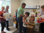 Fruit Valley: Local Windermere employees and their children deliver food to Fruit Valley Elementary School on June 28.