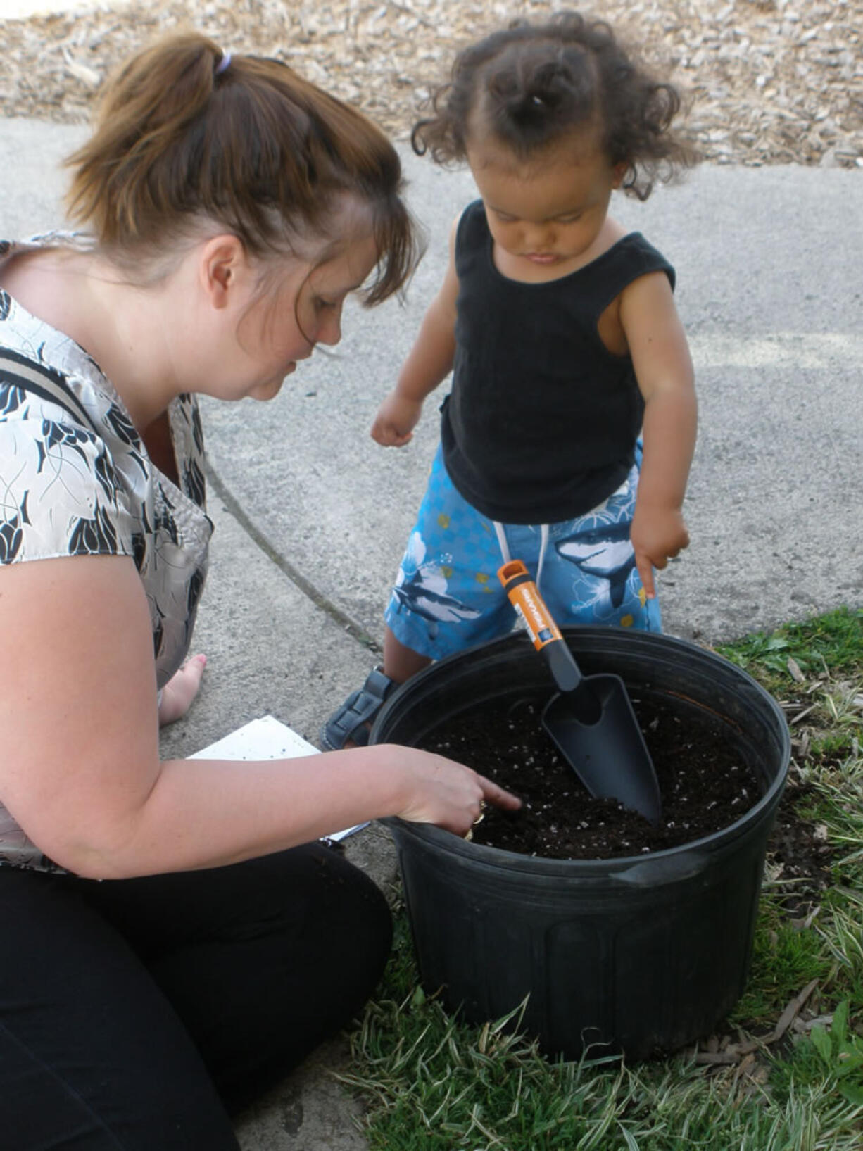 Ellsworth Springs: Lisa VanDelden learns about container gardening with son Steven Petithomme during a June 27 workshop held at the Ellsworth Child Care Center.