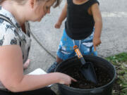 Ellsworth Springs: Lisa VanDelden learns about container gardening with son Steven Petithomme during a June 27 workshop held at the Ellsworth Child Care Center.