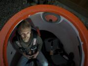 Andy Lehto, a partner in the Camas company Rescue-Pod, demonstrates how to strap in to the two-man tsunami/hurricane/earthquake escape pod .