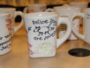 Danielle Ireland and her daughter, Addi Dearinger, who own Earth, Glaze &amp; Fire in Vancouver, reproduced drawings and messages of support collected from community members to create 190 customized coffee mugs for Vancouver police officers.