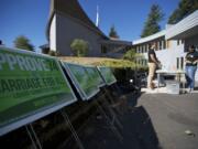 Same-sex marriage advocates Justin Pabalate, 31, and Jessica Nguyen-Ventura, 26, both of Portland, gather at the First Congregational Church in Hazel Dell before volunteers canvassed neighborhoods on Oct.