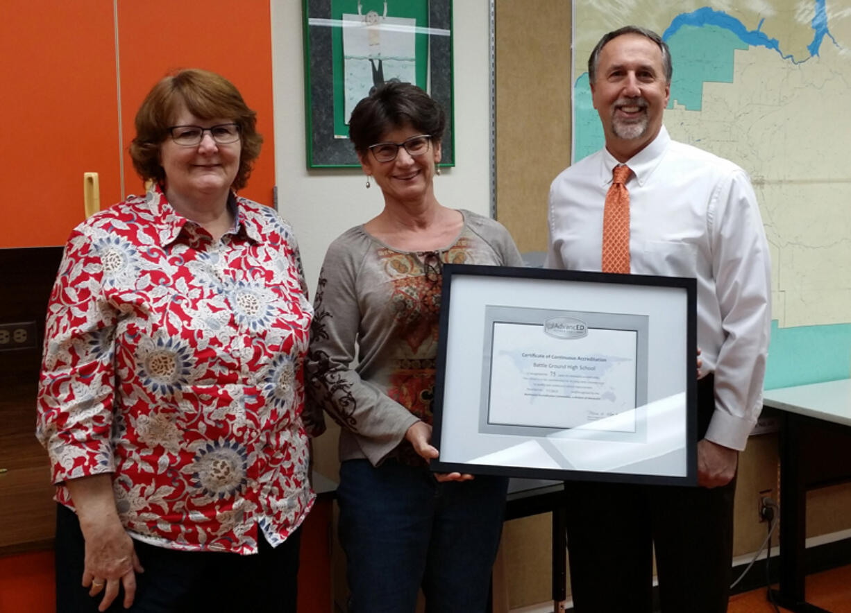 Battle Ground: Battle Ground High School teacher Jamie Hurly, from left, Sheryl Piper, counselor, and Mike Hamilton, principal, celebrate the school&#039;s 75th year of accreditation.