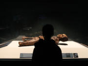 Eli Gomez, 9, views a mummy June 13 at a media preview he attended to write a child's perspective of the &quot;Mummies of the World&quot; exhibition for the Lebanon (Ore.) Express.