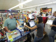 Handy Andy employees Balvin Singh, center, and Brooklynne Gadbury help customer Dennis Juhlin on Thursday. Handy Andy's owner and other neighborhood leaders say that other types of development are needed on St. Johns Road instead of a fourth convenience store within a five-block radius.