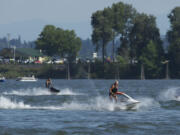 Steven Lane/The Columbian
Personal watercraft riders keep cool Friday by playing on the Columbia River.