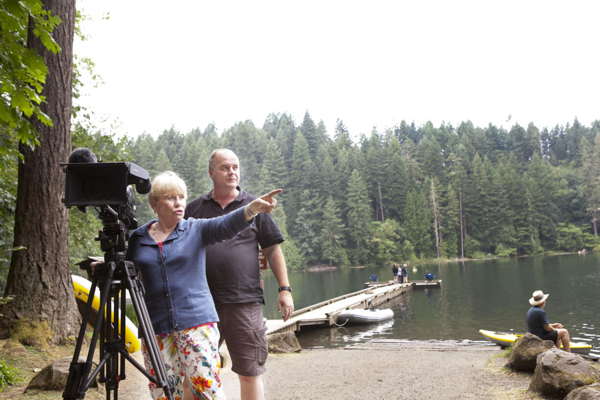 Gretel Rieber-Wicke shows cameraman Horst Poness her old stamping grounds at Battle Ground Lake. Rieber-Wicke of Germany was the first foreign exchange student at Battle Ground High School in 1952.