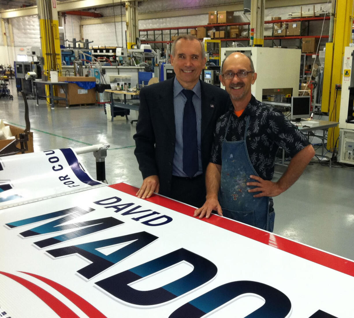 Sign of the times: Newly elected County Commissioner David Madore stands with sign-maker Michael Hurst a few weeks before election day.