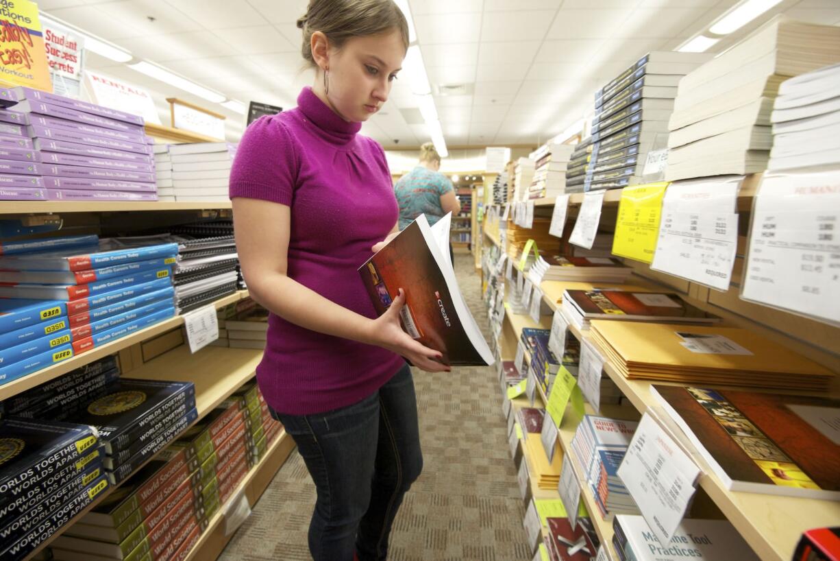 Elizabeth Bible looks over a Japanese language textbook at the student bookstore Monday as fall quarter begins at Clark College.