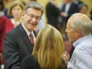 Alan Yordy, president and chief mission officer of PeaceHealth, meets with attendees before speaking about the importance of the health care industry in economic development on Tuesday In Vancouver.