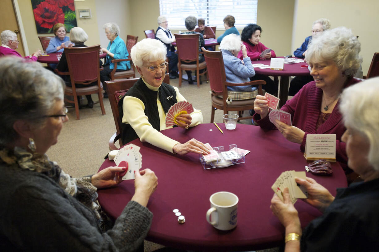 From left, Elizabeth McCoy, 75, Pat Dial, 77, Kathy Ruble, 65, and Maggie Burnham, 81,  enjoy the comraderie at their weekly game of Shanghai at the Fairway Village Clubhouse.