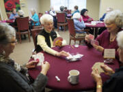 From left, Elizabeth McCoy, 75, Pat Dial, 77, Kathy Ruble, 65, and Maggie Burnham, 81,  enjoy the comraderie at their weekly game of Shanghai at the Fairway Village Clubhouse.