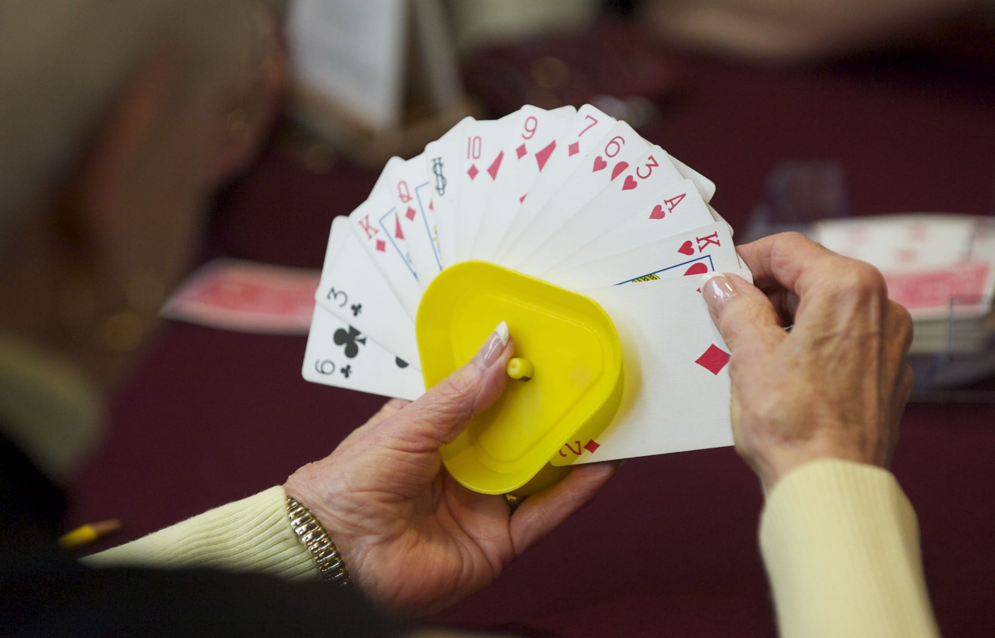 Pat Dial looks at her cards during the weekly Shanghai Rummy game at the Fairway Village Clubhouse.