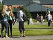 Students, from left, Emily Vis, 20, Miranda Bierscheid, 18, and Kaitlyn McClain, 20, visit during the first day of classes at Washington State University Vancouver on Monday.