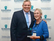 Scleroderma Foundation CEO Robert Riggs, left, stands with Donna Stone of Ridgefield.