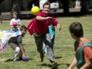 Vancouver Mayor Tim Leavitt plays a game of dodgeball with kids taking part in a day camp at Evergreen Park, which has benefited from donations aimed at keeping the camp running.