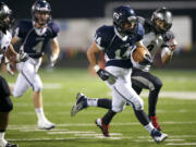 On a fourth and long Kyle Ponciano, 14, of Skyview High School breaks past Union High School defenders for a touchdown during a game at Kiggins Bowl Friday October 26, 2012 in Vancouver, Washington.