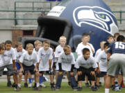 Kids get instructions during the Seahawks junior football training camp at Kiggins Bowl on Sunday.