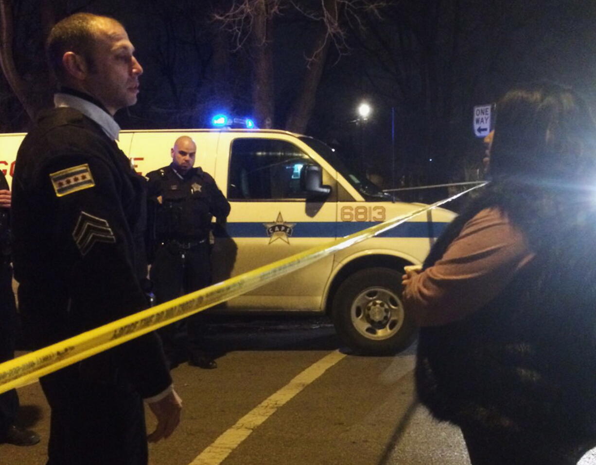 A Chicago police sergeant speaks with a relative of a man who was killed by a police officer in the West Garfield Park neighborhood in Chicago, early Saturday. A Chicago police officer shot and killed two people while responding to a domestic disturbance call in the neighborhood on the city&#039;s West Side, police said.