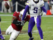 Arizona Cardinals inside linebacker Dwight Freeney (54) forces Minnesota Vikings quarterback Teddy Bridgewater (5) to fumble during the second half of an NFL football game, Thursday, Dec. 10, 2015, in Glendale, Ariz. The Cardinals recovered the ball to secure the 23-20 win. (AP Photo/Ross D.