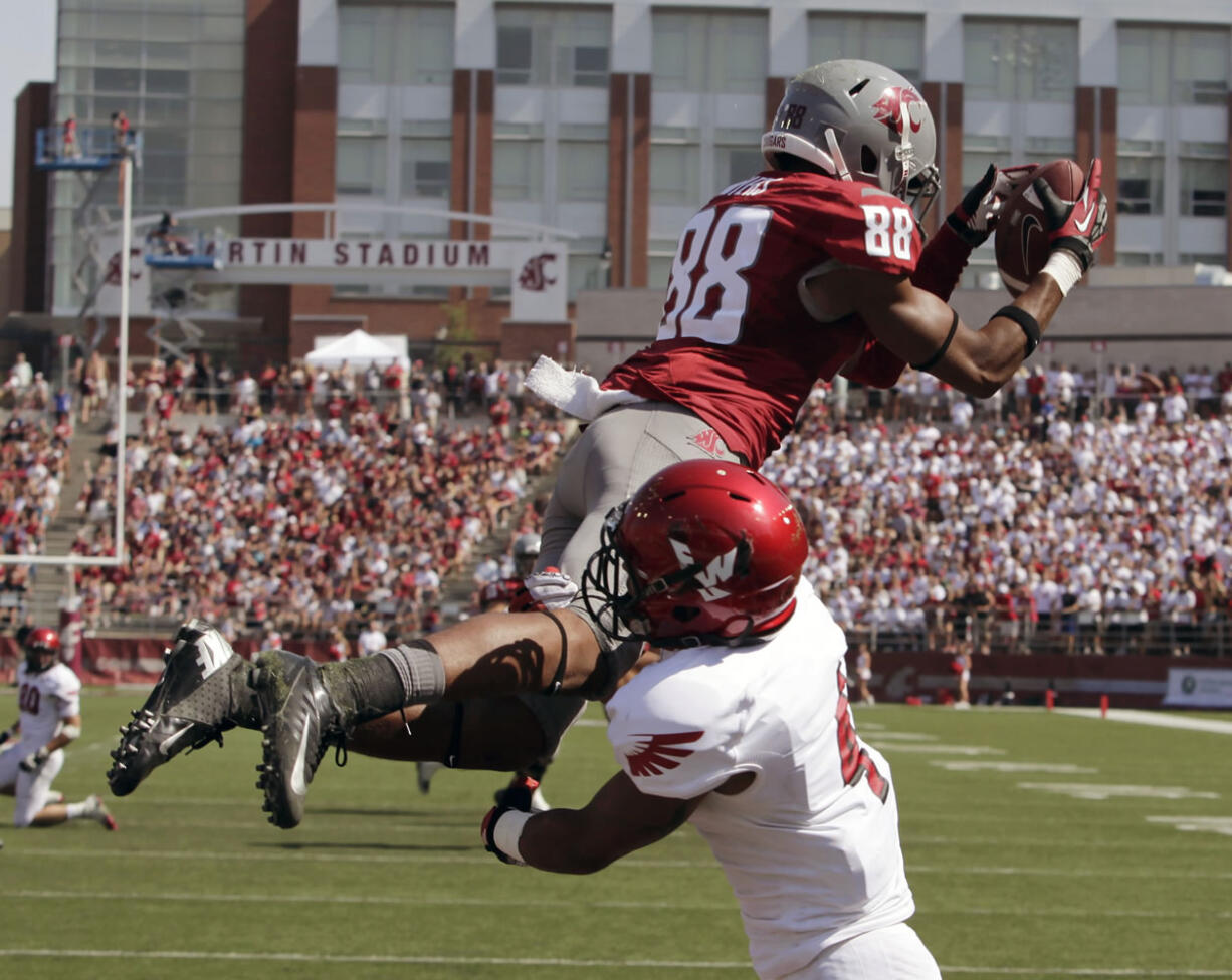 Washington State wide receiver Isiah Myers (88) catches a pass over Eastern Washington defensive back Allen Brown for a 17-yard touchdown from Jeff Tuel during the second quarter Saturday.