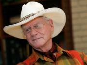 Actor Larry Hagman listens to a reporter's question in 2008 while visiting the Southfork Ranch in Parker, Texas, made famous in the television show &quot;Dallas.&quot; Actor Larry Hagman, who for more than a decade played villainous patriarch JR Ewing in the TV soap Dallas, has died at the age of 81, his family said Saturday.