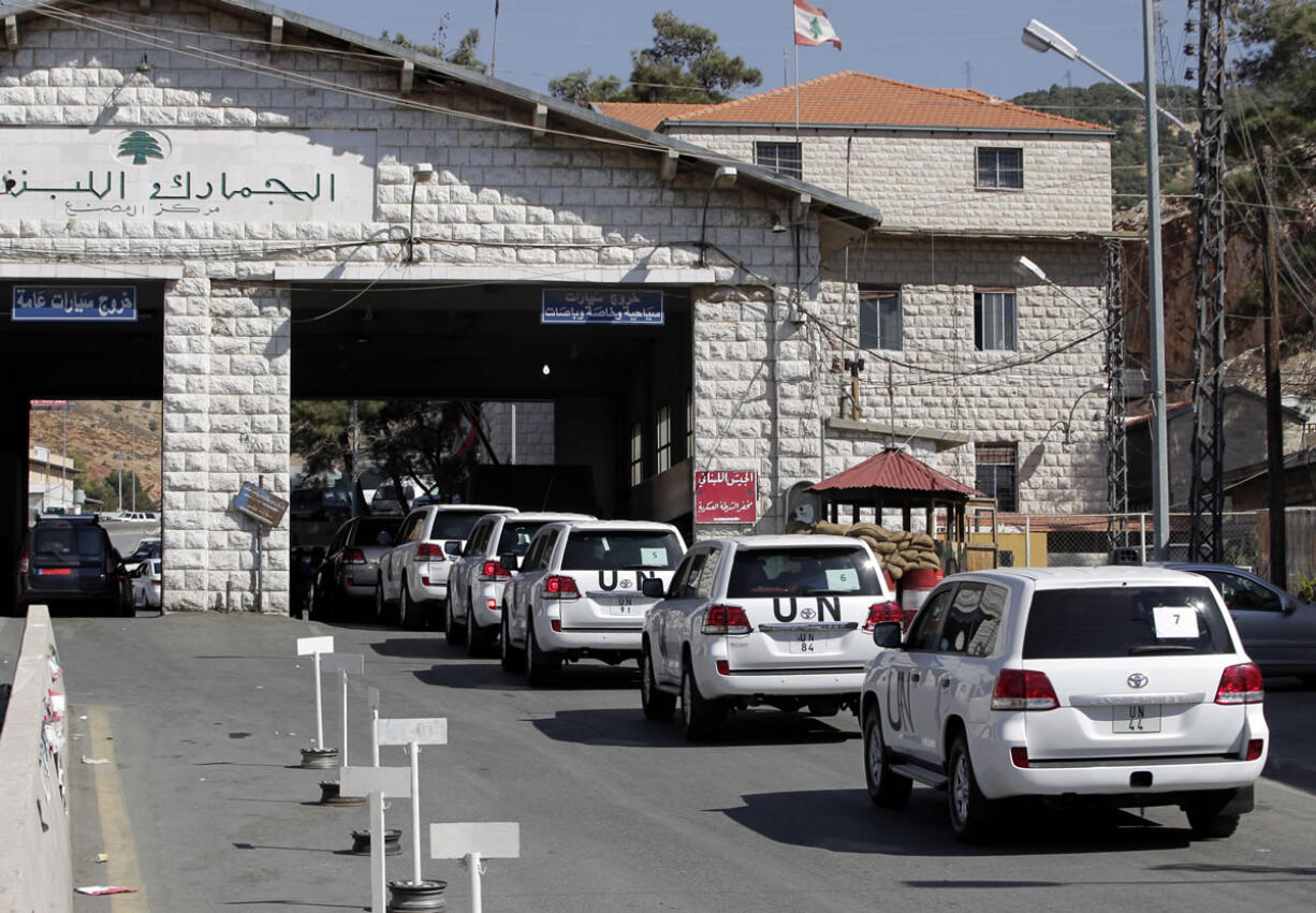 A convoy of inspectors from the Organization for the Prohibition of Chemical Weapons prepares cross into Syria at the Lebanese border crossing point of Masnaa, eastern Bekaa Valley, Lebanon, on Tuesday.