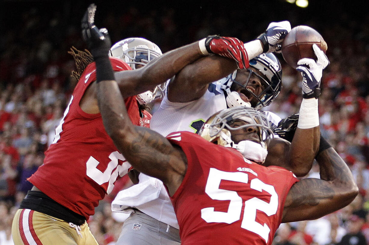 San Francisco 49ers linebacker Patrick Willis (52) and safety Dashon Goldson break up a pass intended for Seattle Seahawks wide receiver Braylon Edwards during the second quarter of an NFL football game in San Francisco, Thursday, Oct. 18, 2012.