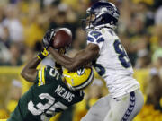 Seattle Seahawks' Stephen Williams catches a touchdown pass over Green Bay's Loyce Means during the second half Friday.