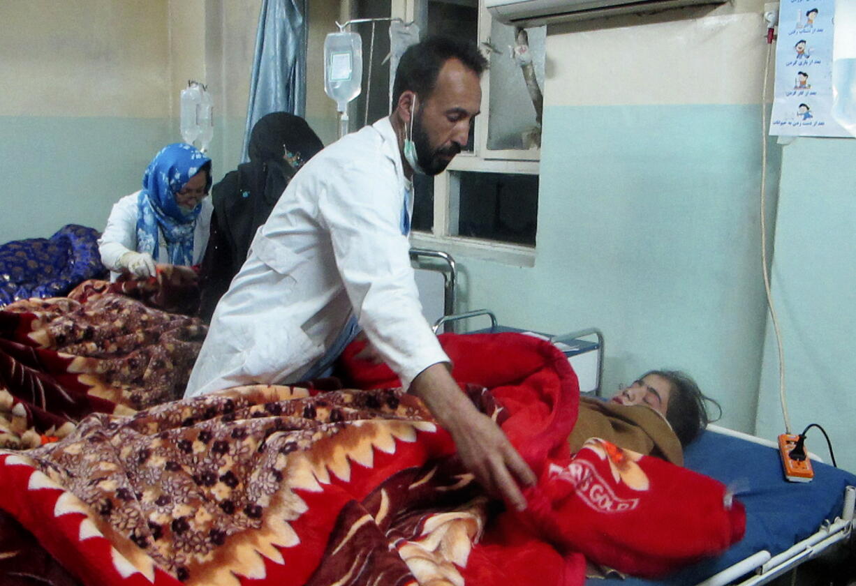 Hospital staff help treat wounded children after a roadside bomb struck a small bus coming from a wedding killing dozens, mostly women and children, at the hospital in Ghazni, Afghanistan, Sunday, Oct 27, 2013. The blast occurred in the Andar district as the bus traveled from one village to another just before dusk. Andar is one of the few districts in Ghazni where the Taliban retain some measure of control and often attack security forces, mostly by laying bombs along roads.