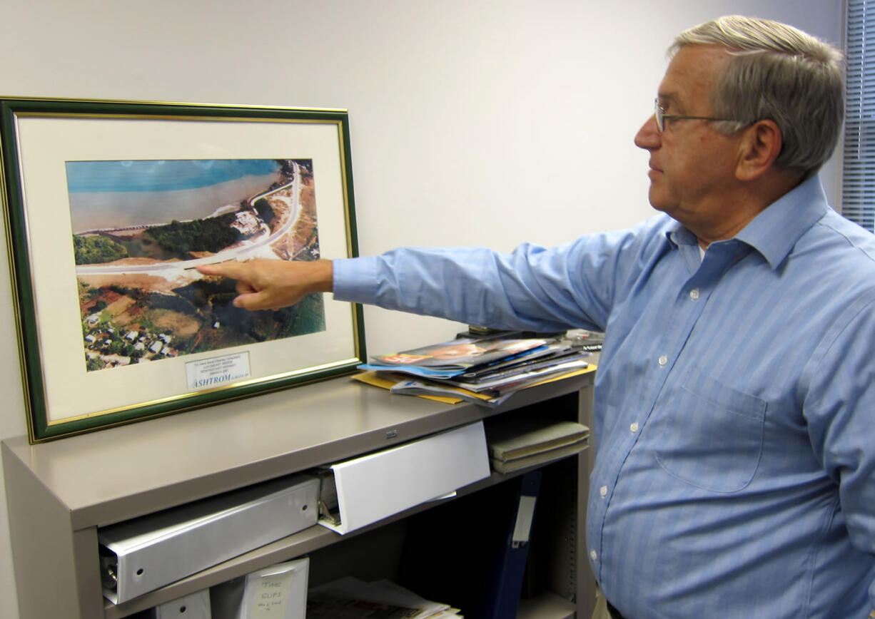 This photo taken May 3, 2013 shows Hank Mann, 72, an engineer at Stanley Consultants, pointing at an image of a highway project he worked on, at the companyis headquarters in Muscatine, Iowa. Mann is among the employees at Stanley who have participated in iphased retirement,i in which a worker can cut back their hours in the months or years before their formal retirement, and continue to work part-time after. Employers around the country offer phased retirement, giving older workers a chance to transition more slowly to their post-career life.