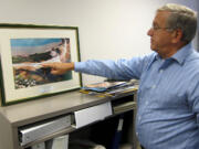 This photo taken May 3, 2013 shows Hank Mann, 72, an engineer at Stanley Consultants, pointing at an image of a highway project he worked on, at the companyis headquarters in Muscatine, Iowa. Mann is among the employees at Stanley who have participated in iphased retirement,i in which a worker can cut back their hours in the months or years before their formal retirement, and continue to work part-time after. Employers around the country offer phased retirement, giving older workers a chance to transition more slowly to their post-career life.