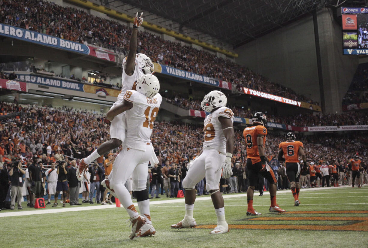 Texas wide receiver Marquise Goodwin is lifted after his 36-yard touchdown catch in the fourth quarter against Oregon State in the Alamo Bowl on Saturday.