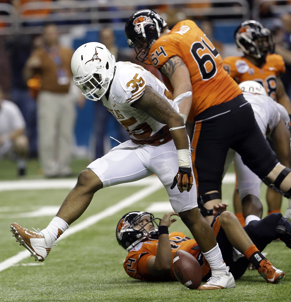 Texas' Kendall Thomas (35) celebrates after sacking Oregon State's Cody Vaz (14) during the fourth quarter of the Alamo Bowl NCAA football game, Saturday, Dec. 29, 2012, in San Antonio.  Texas won 31-27.