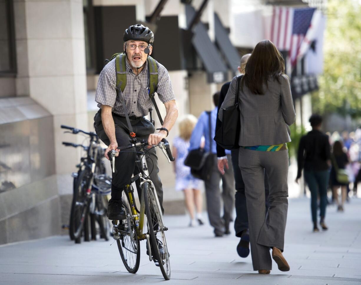 David Hilfiker, of Washington, D.C., leaves the National Press Club on his bike Sept. 19 after talking about his life with Alzheimer's disease.