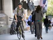 David Hilfiker, of Washington, D.C., leaves the National Press Club on his bike Sept. 19 after talking about his life with Alzheimer's disease.