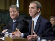 American Airlines and AMR Corporation Chairman, President and CEO Thomas Horton, right, accompanied by US Airways Group Chairman and CEO Douglas Parker, testifies on Capitol Hill in Washington on March 19.