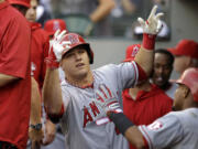 Los Angeles Angels' Mike Trout motions in the dugout after hitting a two-run home run against the Seattle Mariners in the first inning Saturday.