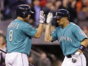 Seattle Mariners' Raul Ibanez, right, is congratulated by on-deck batter Kendrys Morales after Ibanez' home run against the Los Angeles Angels in the sevent inning of a baseball game Friday, July 12, 2013, in Seattle. Morales homered on his turn.