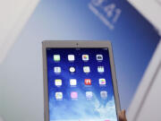 An Apple employee holds up the new iPad Air on Tuesday in San Francisco.