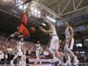 Arizona's Mark Tollefsen (23) dunks in front of Gonzaga's Kyle Wiltjer, center, and Kyle Dranginis during the second half of an NCAA college basketball game, Saturday, Dec. 5, 2015, in Spokane, Wash. Arizona won 68-63.