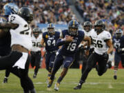 Navy quarterback Keenan Reynolds (19) rushes during an NCAA college football game against Army Saturday, Dec. 12, 2015, in Philadelphia.