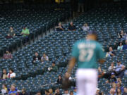 Only a few fans are in the stands near first base at Safeco Field as Seattle Mariners starting pitcher Taijuan Walker takes the mound for Monday's game against the Houston Astros.