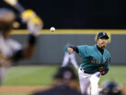 Seattle Mariners starting pitcher Hisashi Iwakuma throws to Oakland's Yoenis Cespedes in the sixth inning Friday.