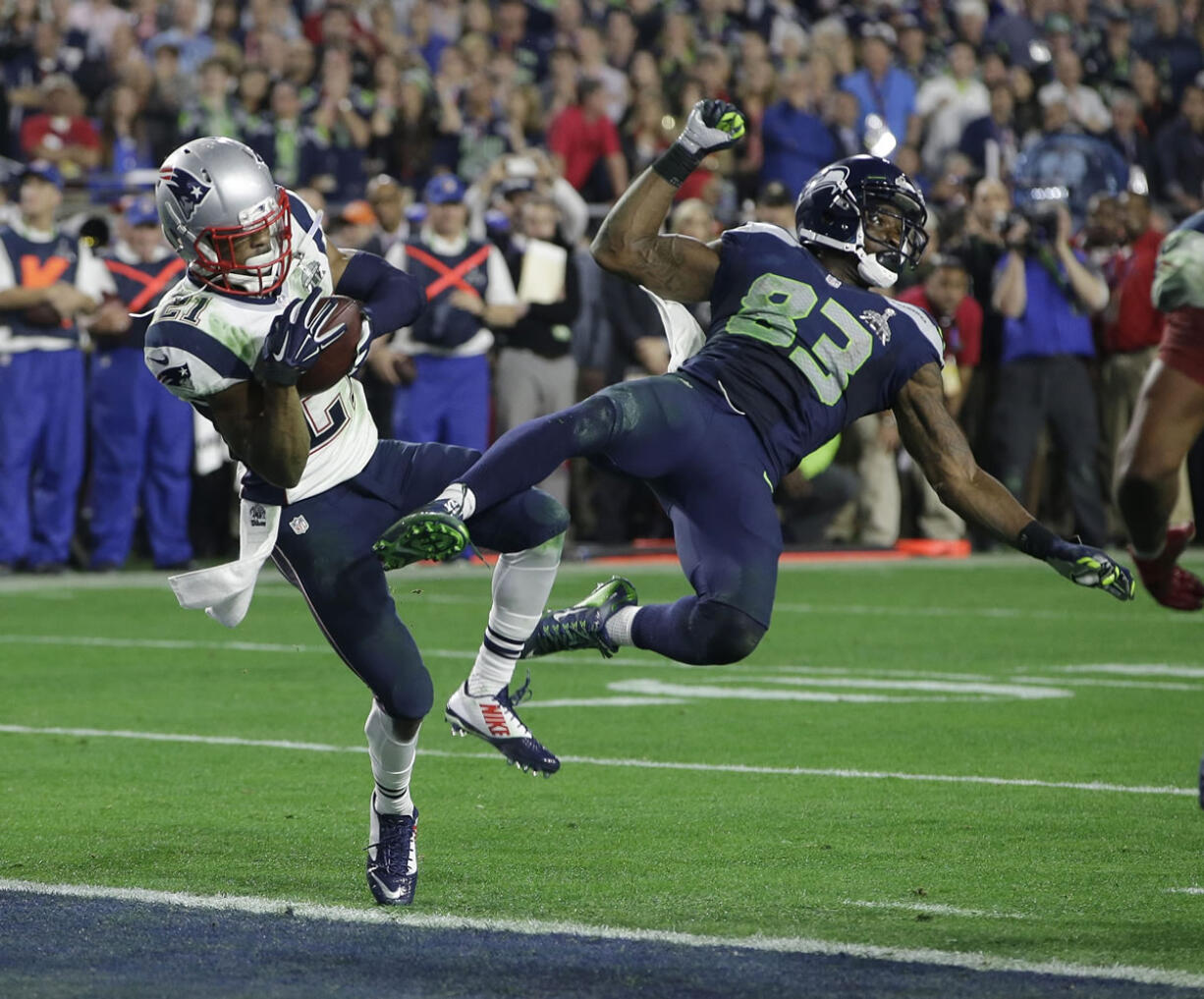 New England Patriots cornerback Malcolm Butler (21) intercepts a pass intended for Seattle Seahawks wide receiver Ricardo Lockette (83) during the closing seconds of Super Bowl XLIX, in Glendale, Ariz. The Seahawks' return to the same stadium on Sunday for the first time since February to take on the Arizona Cardinals.